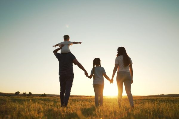 Family walking at sunset during summer ©Taty77