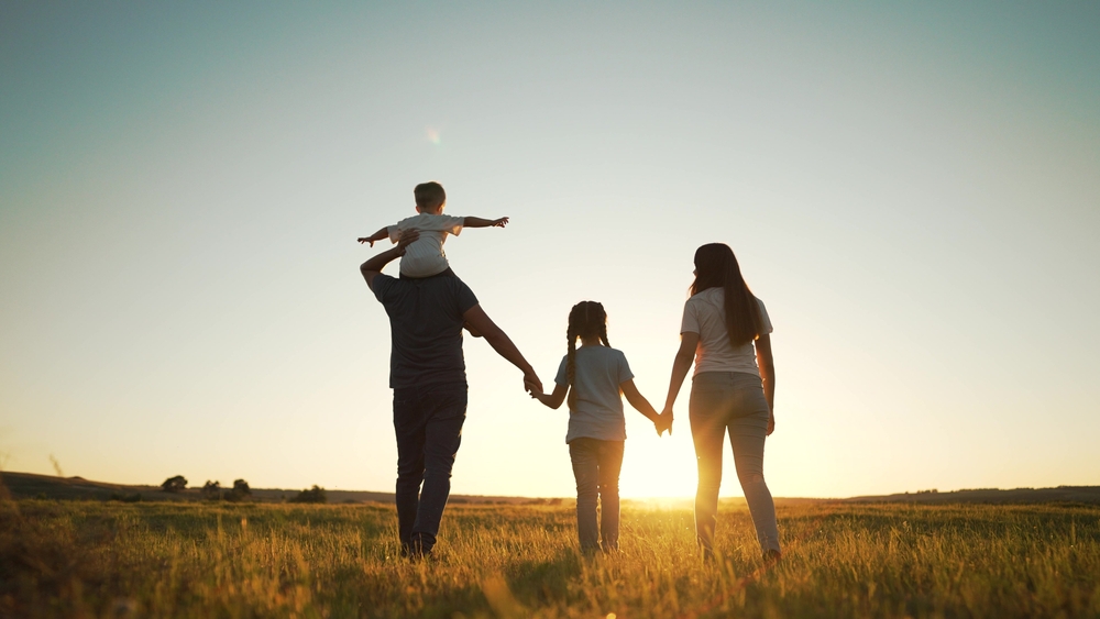 Family walking at sunset during summer ©Taty77