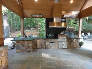 an outdoor kitchen and dining area