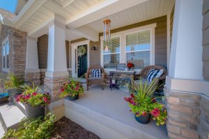 Covered front porch with seating and potted plants (stock image).©Jason Finn *Inspiration image — not a Norm Hughes Homes project