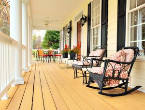 Covered front porch with seating and potted plants (stock image).©Christopher Edwin Nuzzaco *Inspiration image — not a Norm Hughes Homes project