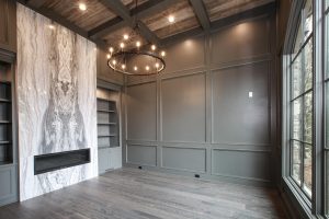 Primary bedroom with custom statement fireplace, stone surround, and boutique-hotel style design