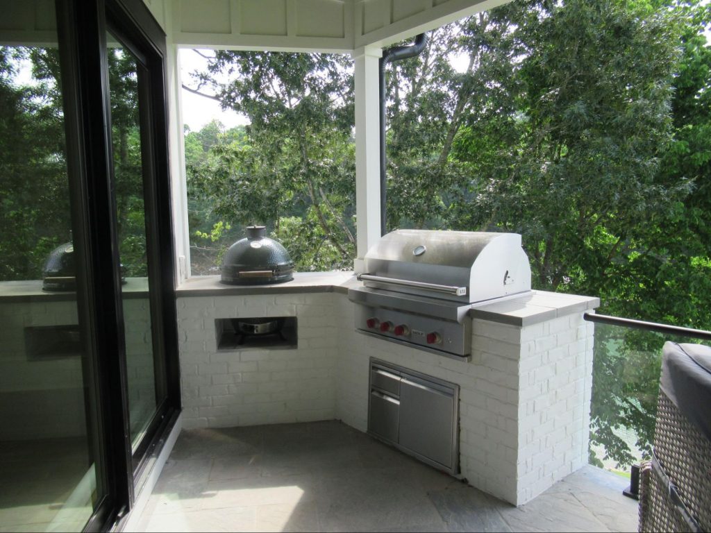 White brick outdoor kitchen on back porch.